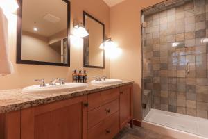 a bathroom with two sinks and a shower at Slalom Creek 2 Bedroom & Den in Rossland