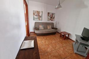 a living room with a couch and a table at Viviendas Casa Abuela in El Paso