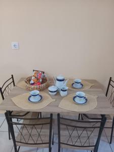 a wooden table with blue and white dishes on it at The Spring House in Tyros +6 photos