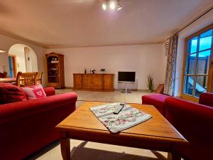 a living room with a couch and a coffee table at Ferienwohnung Soiernseelig in Wallgau