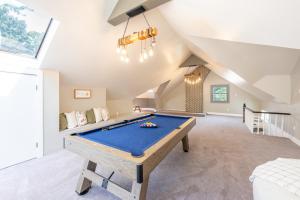 a pool table in the middle of a room at Casa Francesca 6BR Villa & Heated Pool in Roselle