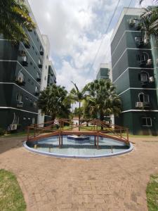a pool in the middle of two tall buildings at Loft do Bosque in Ananindeua