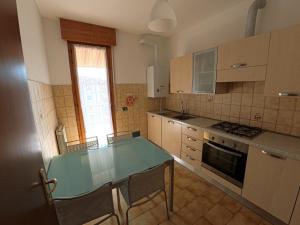 a kitchen with a table and chairs in it at Casa Giulia in Domodossola