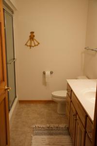 a bathroom with a toilet and a sink at Fishtrap Lake Lodge 4400 sq feet 6 bedroom 3 bath in Boulder Junction +23 photos