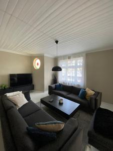 a living room with a couch and a table at Centrally located 6-room detached house in Haugesund