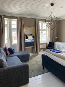 a living room with two beds and a mirror at Centrally located 6-room detached house in Haugesund