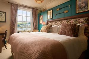 a bedroom with a large bed and a window at The Royal Castle in Dartmouth