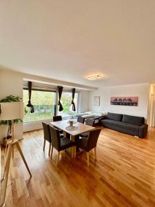 a living room with a table and a couch at Spacious Modern Apartment with Free Parking in Gerasdorf bei Wien