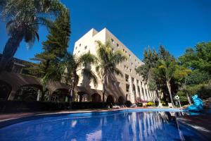 a building with a swimming pool in front of it at Hotel Ex-Hacienda San Xavier in Guanajuato