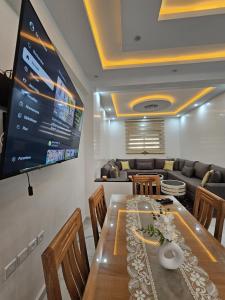 a dining room with a table and a tv at Appartement Casa in Essaouira