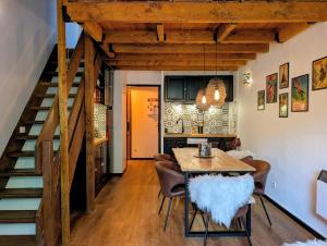 a kitchen and dining room with a table and chairs at Le CerfBlanc in Les Angles