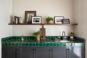 a kitchen with a green counter top and a sink at Casa Cody in Palm Springs +43 photos
