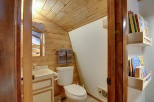 a small bathroom with a toilet and a sink at Unique Forest Cabin with Deck Ski, Hike, Fish! in Duck Creek Village +19 photos