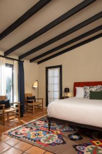 a bedroom with a large bed and a large rug at Casa Cody in Palm Springs