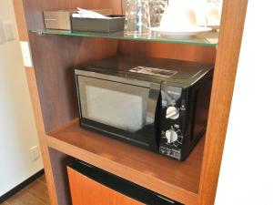 a microwave oven sitting on a wooden shelf at SA Inn Nagano Nakagosho - Vacation STAY 45404v in Nagano