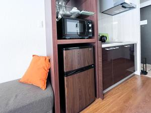 a small room with a tv and a cabinet with a microwave at SA Inn Nagano Nakagosho - Vacation STAY 45404v in Nagano