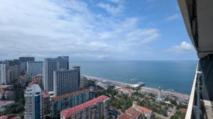 a view of the city and the ocean from a building at Orbi City, block C in Batumi