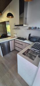 a kitchen with a sink and a stove in it at Cabaña Serrano in Linares