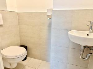 a bathroom with a toilet and a sink at Luxury Apartment with Balcony & Free Parking in Vienna +5 photos