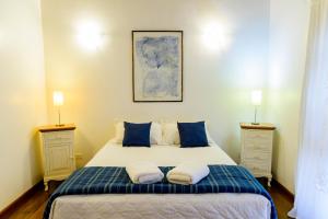 a bedroom with a large bed with two night stands at Haras Buona Fortuna in Cotia