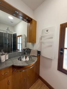 a kitchen with a sink and a refrigerator at la maison du soleil in Sigean