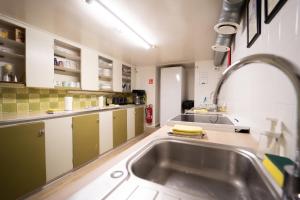 a kitchen with a sink and a counter top at 1908 Hostel by Tröll in Vík