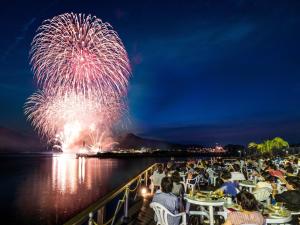 a crowd of people sitting at tables watching a fireworks display at Kaamlanai Harbor - Vacation STAY 48668v in Nichinan