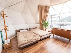 a bedroom with a bed in a tent at Kaamlanai Harbor - Vacation STAY 48668v in Nichinan