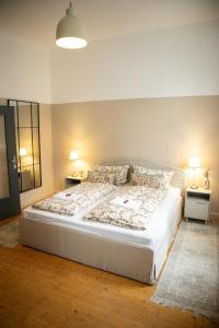 a bedroom with a large bed with two night stands at Kassel Rooms - Davinci Apartment in Kassel
