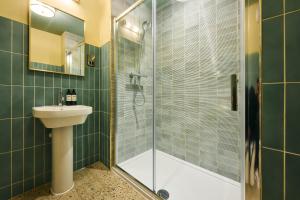 a bathroom with a shower with a sink and a toilet at The Royal Castle in Dartmouth +62 photos