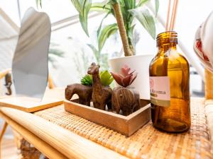 a table with a bottle of essential oils and a plant at Kaamlanai Harbor - Vacation STAY 48796v in Nichinan