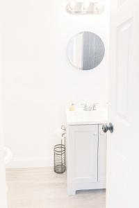 a white bathroom with a sink and a mirror at Relaxing Retreat in Sunny Bonita Springs in Bonita Springs