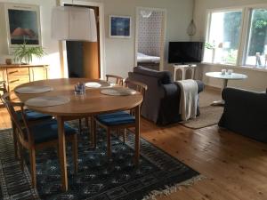 a living room with a table and a couch at 4 person holiday home in SKÅNES-FAGERHULT in Skånes Fagerhult