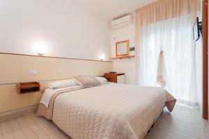 A bed or beds in a room at B&B Airone Cervia - Camere e Appartamenti
