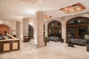 a lobby with chairs and tables in a building at Hotel Ex-Hacienda San Xavier in Guanajuato