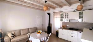 a living room with a couch and a table at House Lantina Kornati in Kravljačica