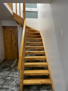 a wooden staircase in a room with a door at Gran casa con preciosa vista in Huasco