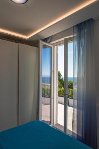 a bedroom with a bed and a view of the ocean at Maison Margot in Forio d'Ischia +14 photos