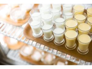 a bunch of glasses of milk on a tray at HOTEL Noir Blanc - Vacation STAY 97962v in Shizuoka
