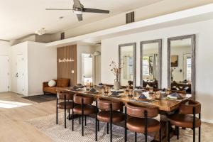a dining room with a large wooden table and chairs at Sapphire Haven, Pickleball, Stars & Desert Views in Joshua Tree