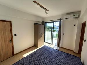 an empty room with a door and a bed at Avana apartment in Flic-en-Flac +4 photos