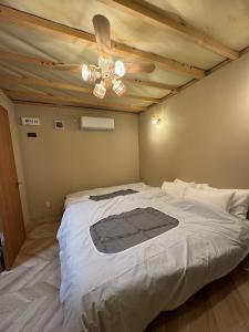 a bedroom with a large bed with a ceiling at Fujimi no Oka Auto Campsite - Vacation STAY 27845v in Fuji