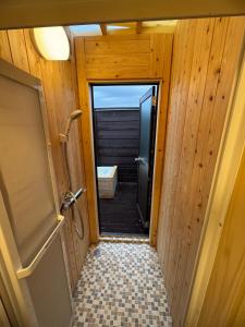 a door to a bathroom with a walk in shower at Fujimi no Oka Auto Campsite - Vacation STAY 27846v in Fuji