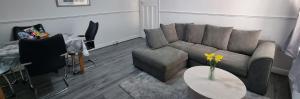 a living room with a couch and a table at Tyne Relaxation in Newcastle upon Tyne