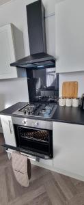 a kitchen with a stove top oven in a kitchen at Tyne Relaxation in Newcastle upon Tyne