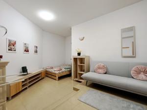 a living room with a couch and a table at pokoje przytulnie jak w domu in Kraków