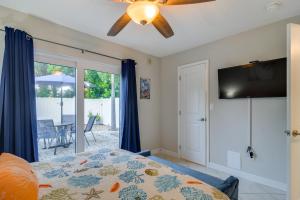 a bedroom with a bed and a flat screen tv at Near Beach! Modern Ground-Floor Condo in St Pete in St Pete Beach +20 photos