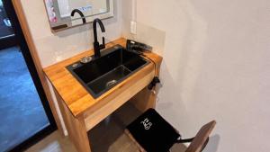 a sink in a kitchen with a chair next to it at oceanhouse iseshima - Vacation STAY 67855v in Kō