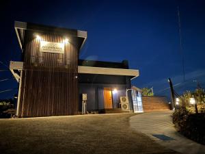 a building with a sign on it at night at oceanhouse iseshima - Vacation STAY 67873v in Kō