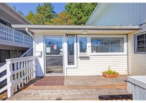 a front door of a house with a porch at Capital O Stevenson Inn Riverside in Stevenson